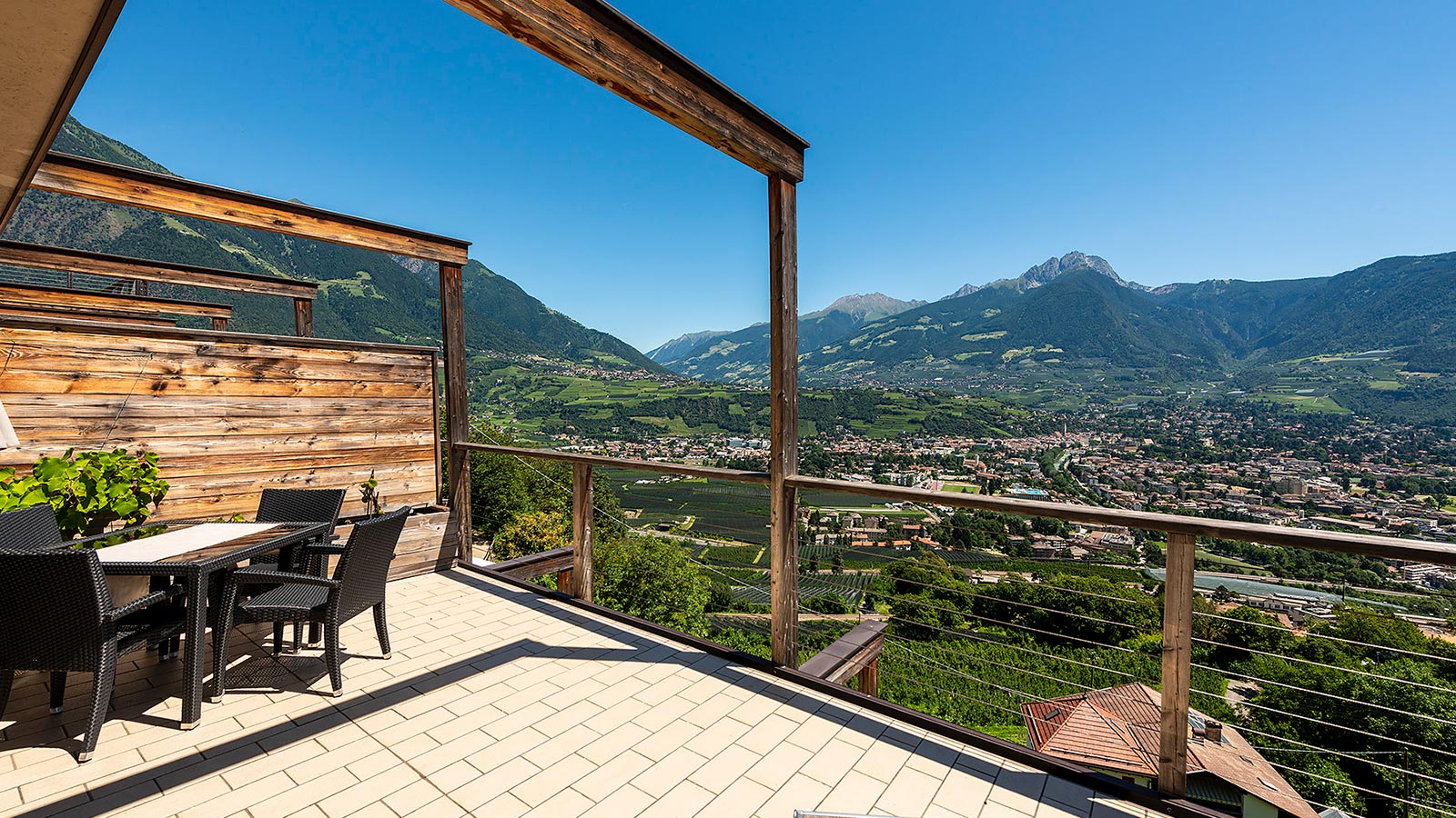 The terrace of our Residence holiday apartments in Marlengo with a view of the valley